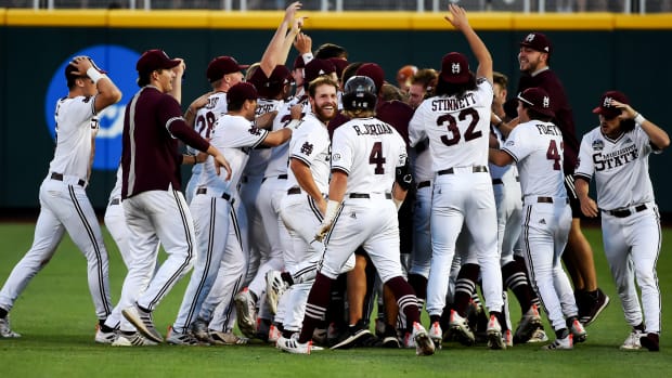 Jun 26, 2021; Omaha, Nebraska, USA; Tje Mississippi State Bulldogs celebrate the win against the Texas Longhorns at TD Ameritrade Park.